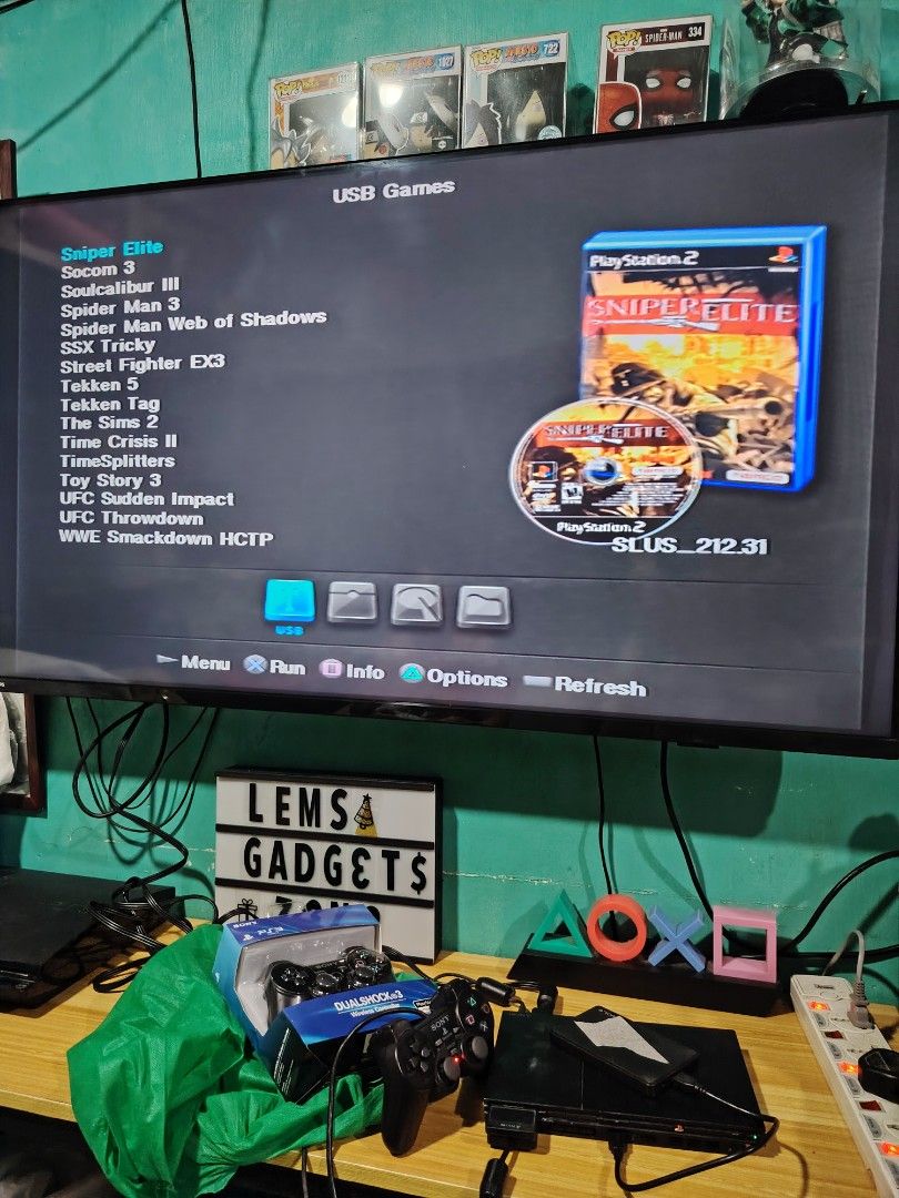 PlayStation 2 Games USB Games (Category: PlayStation) located in Manila. Submitted by lemsgadgetszone (Listing ID 1414225065, Image 3). Description: Offering a selection of PlayStation 2 games playable via USB. Games include Alone in the Dark, Guitar Hero III, Sniper Elite, WWE Smackdown vs Raw 2011, and Need for Speed Underground 2. The console and controllers are also included. Please inquire for specific game availability and pricing..