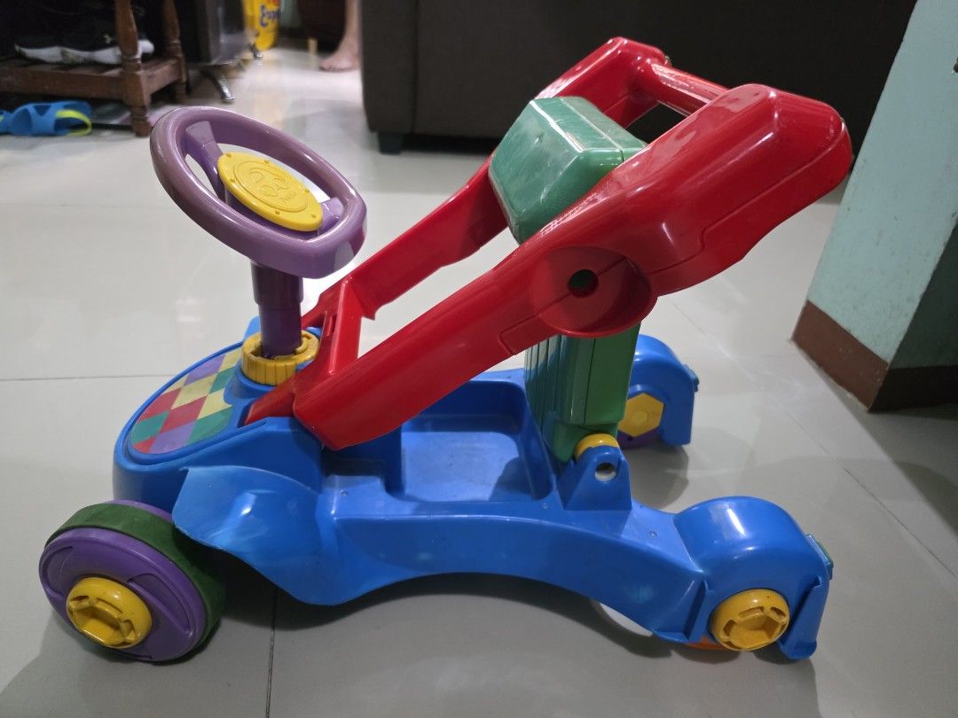 Push Walker / Ride-on car (Category: Infant Playtime) located in Manila. Submitted by iamsham (Listing ID 1414249499, Image 2). Description: Convertible push walker to ride-on car for babies. Pre-loved item with visible scratches and signs of normal use. Fully functional, but please manage expectations as this is not brand new..