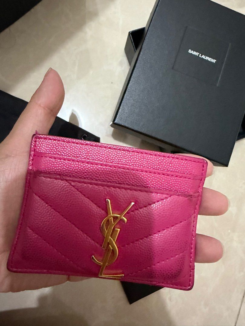 Saint Laurent YSL Card Holder (Category: Luxury Bags & Wallets) located in Paranaque City. Submitted by pumpkin1210 (Listing ID 1414160014, Image 2). Description: - Authentic Saint Laurent card holder - Vibrant pink color - Features gold YSL logo - Includes original box, dust bag, and authenticity card - Multiple card slots - Stylish and practical accessory.