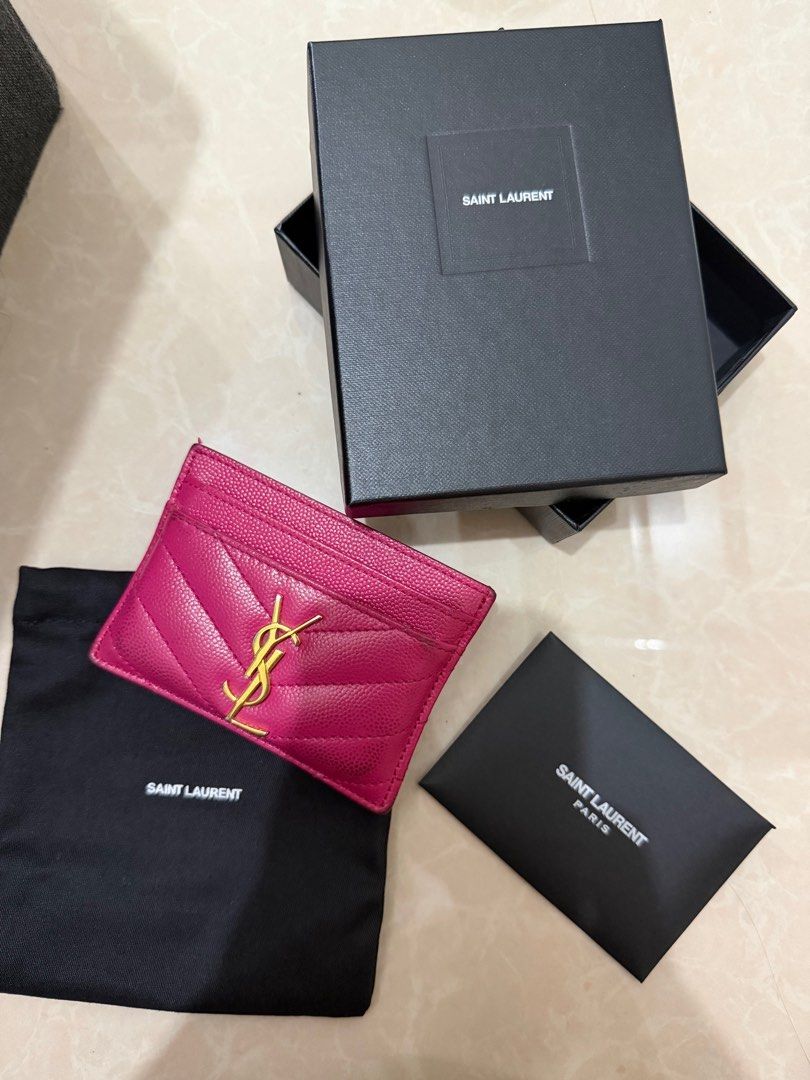 Saint Laurent YSL Card Holder (Category: Luxury Bags & Wallets) located in Paranaque City. Submitted by pumpkin1210 (Listing ID 1414160014, Image 1). Description: - Authentic Saint Laurent card holder - Vibrant pink color - Features gold YSL logo - Includes original box, dust bag, and authenticity card - Multiple card slots - Stylish and practical accessory.