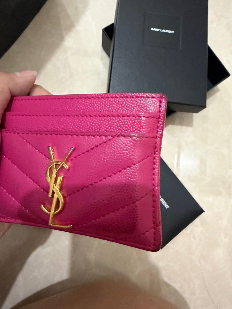 Saint Laurent YSL Card Holder (Category: Luxury Bags & Wallets) located in Paranaque City. Submitted by pumpkin1210 (Listing ID 1414160014, Image 3). Description: - Authentic Saint Laurent card holder - Vibrant pink color - Features gold YSL logo - Includes original box, dust bag, and authenticity card - Multiple card slots - Stylish and practical accessory.