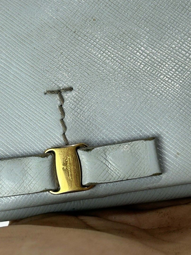 Salvatore Ferragamo Bow Wallet (Category: Luxury Bags & Wallets) located in Caloocan City. Submitted by snoworiontwinkle_08 (Listing ID 1414168361, Image 2). Description: - Authentic Salvatore Ferragamo wallet - Light blue color - Bow detail on the front - Multiple card slots - Coin compartment - Brand name visible inside - Serial number visible - Made in Italy.