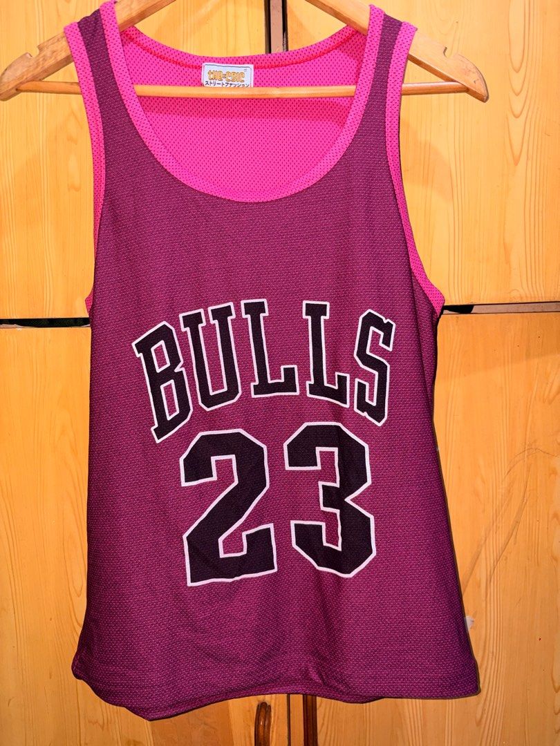 The Chic Chicago Bulls 23 Jersey (Category: Activewear) located in Manila. Submitted by ciiii1 (Listing ID 1414216209, Image 1). Description: - Reversible Chicago Bulls jersey - Features the iconic Bulls logo and #23 - Pink mesh inner layer - Maroon outer layer - Sleeveless design - Made of breathable material.