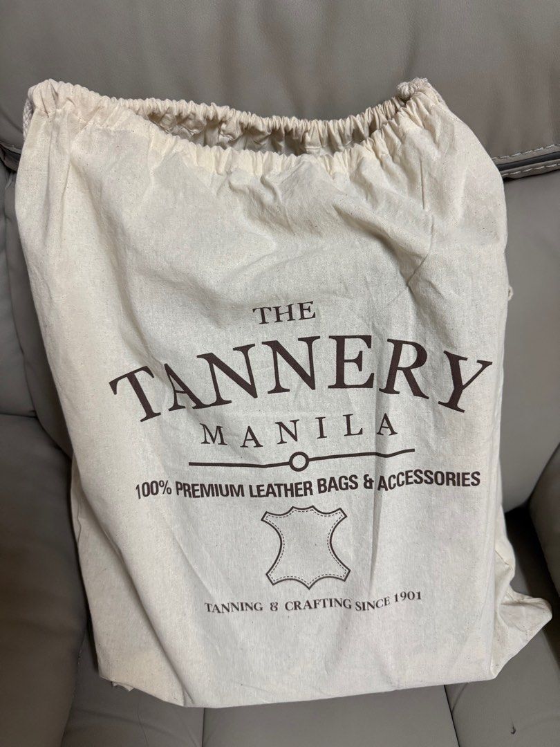 The Tannery Manila Leather Bag (Category: Luxury Bags & Wallets) located in Manila. Submitted by barbie.closet (Listing ID 1414192216, Image 2). Description: - Brand: The Tannery Manila - Material: Genuine Leather - Color: Reddish Brown - Closure: Zipper - Features: - Includes dust bag and original tags - Interior zippered pocket - Perfect for carrying essentials - Made with 100% premium leather Around 15” in width. Can fit MacBook Pro or any lap