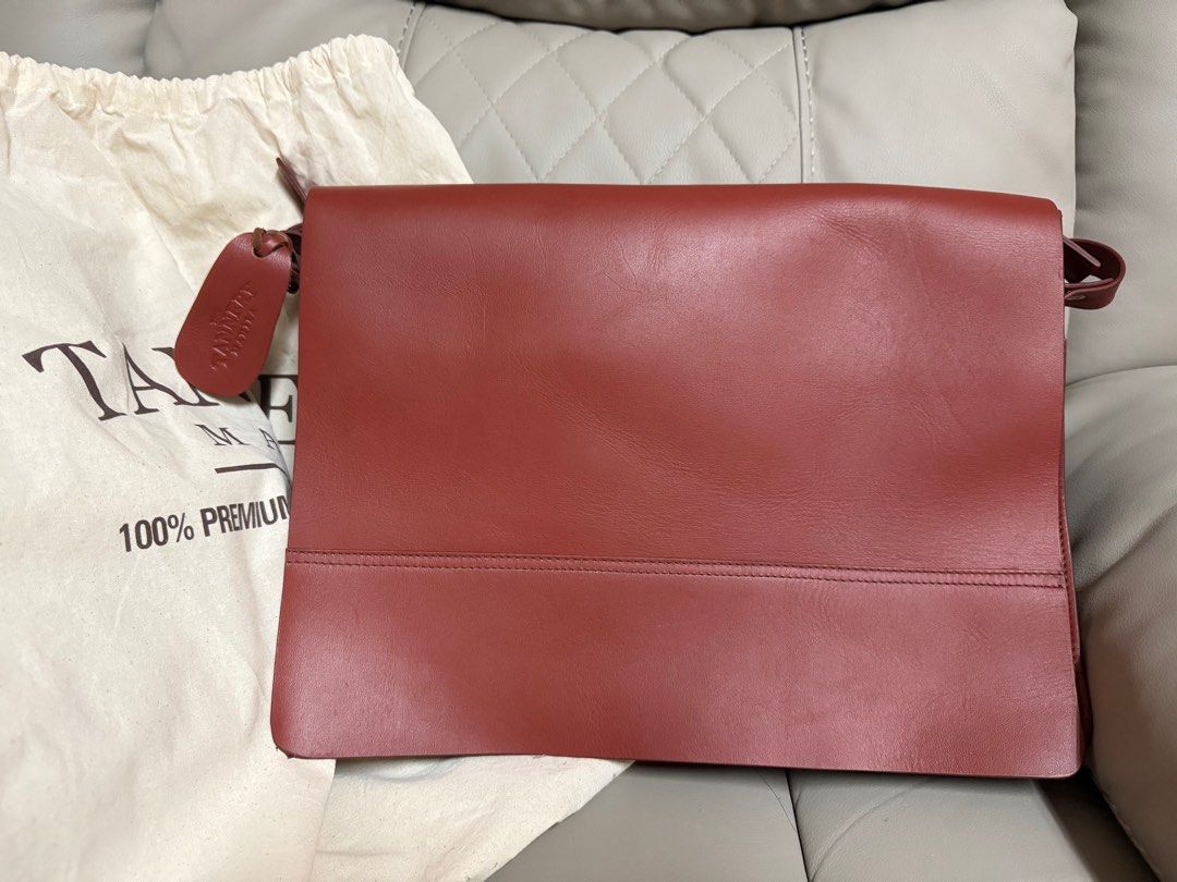The Tannery Manila Leather Bag (Category: Luxury Bags & Wallets) located in Manila. Submitted by barbie.closet (Listing ID 1414192216, Image 1). Description: - Brand: The Tannery Manila - Material: Genuine Leather - Color: Reddish Brown - Closure: Zipper - Features: - Includes dust bag and original tags - Interior zippered pocket - Perfect for carrying essentials - Made with 100% premium leather Around 15” in width. Can fit MacBook Pro or any lap