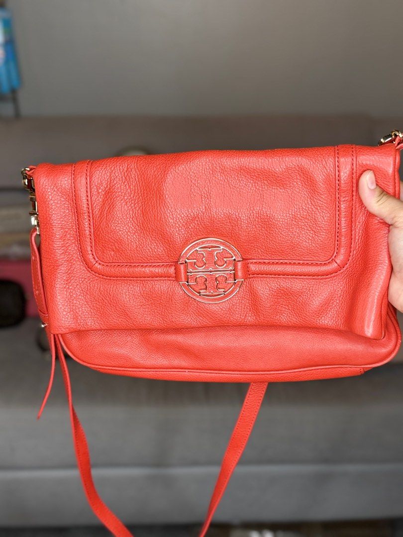 Tory Burch Crossbody Bag (Category: Luxury Bags & Wallets) located in Manila. Submitted by ahmazing (Listing ID 1414111196, Image 1). Description: - Authentic Tory Burch crossbody bag - Eye-catching orange color - Signature logo detail - Secure flap closure - Adjustable long strap - Crafted from textured leather - Ideal for daily use.