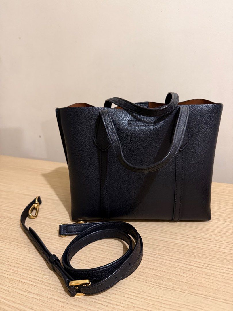 Tory Burch Perry Small Tote Bag (Guaranteed Original) (Category: Luxury Bags & Wallets) located in Davao. Submitted by abdullahal43824 (Listing ID 1414205004, Image 3). Description: - Tory Burch Perry Small Tote Bag - Black exterior, brown interior - Detachable shoulder strap - Red and gold charm - Top handle - Zipper closure - Small interior pocket - Tory Burch logo on front.