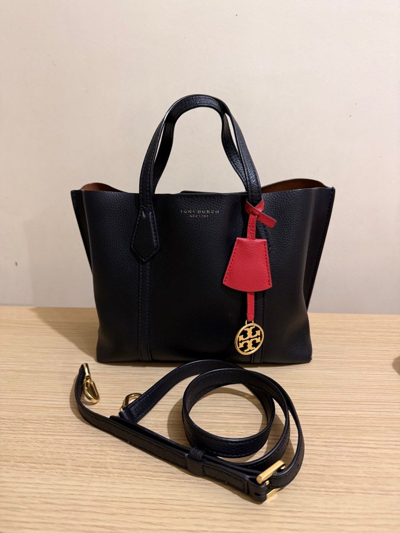 Tory Burch Perry Small Tote Bag (Guaranteed Original) (Category: Luxury Bags & Wallets) located in Davao. Submitted by abdullahal43824 (Listing ID 1414205004, Image 1). Description: - Tory Burch Perry Small Tote Bag - Black exterior, brown interior - Detachable shoulder strap - Red and gold charm - Top handle - Zipper closure - Small interior pocket - Tory Burch logo on front.