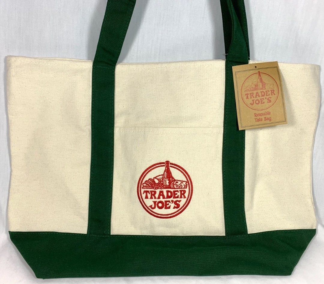 Trader Joe's LARGE Reusable Tote Bag (Category: Tote Bags) located in Marikina City. Submitted by declutter_new (Listing ID 1414197021, Image 1). Description: Bought many Stock: 3 Trader Joe's reusable tote bag features a cream-colored body with green accents and handles. It has the Trader Joe's logo prominently displayed on the front. The bag includes a tag that reads "Reusable Tote Bag". AI description yan a HAHAHHA.