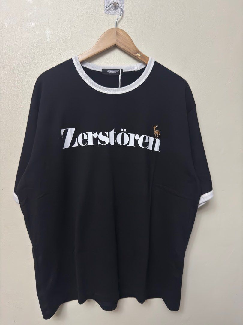 Undercover Japan Oversize Ringer Tee - Black/White (Category: Luxury Apparel) located in Dasmarinas. Submitted by phamhannii (Listing ID 1414207163, Image 1). Description: Undercover Japan by Jun Takahashi - Zerstören Graphic Oversize Ringer Tee 100% Cotton Size: 3 on tag Dimes (WxL): 25.5 x 29.5 inches Color Rate: 10/10 Condition Rate: 10/10 Excellent Condition All items are washed and sanitized. Flexible payment options. Shipping via J&T, Lalam