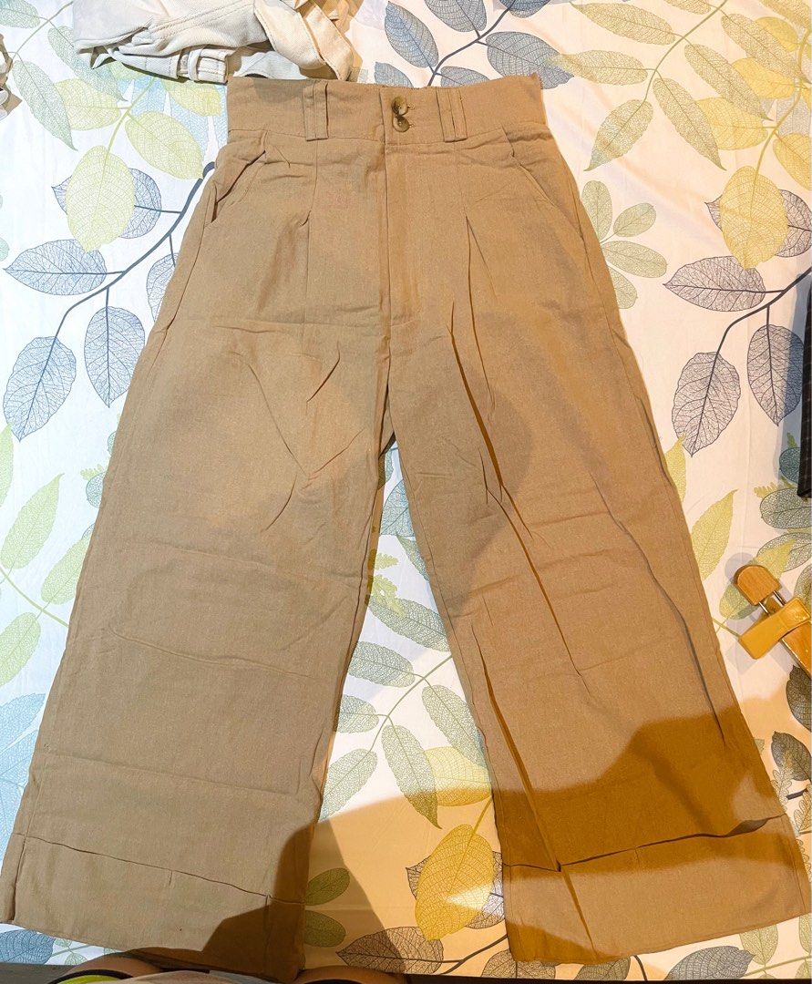 Wide Leg Trousers - khaki (Category: Other Bottoms) located in Cainta. Submitted by coatclosetph (Listing ID 1414202881, Image 1). Description: - Beige wide-leg trousers - High-waisted design - Features pleats and pockets - Button and zipper closure - Suitable for casual and semi-formal occasions -24-26 waist.