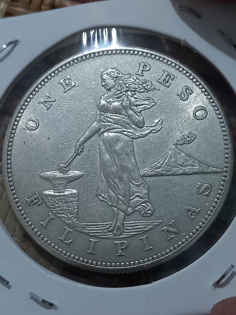 1902 US Philippines One Peso copy Coin (Category: Currency) located in Subic. Submitted by regiegabriel29 (Listing ID 1414293189, Image 2). Description: - Vintage coin from 1902. - Features "UNITED STATES OF AMERICA" on one side. - Displays "ONE PESO FILIPINAS" on the other side. - Silver in color. - Well-preserved condition..