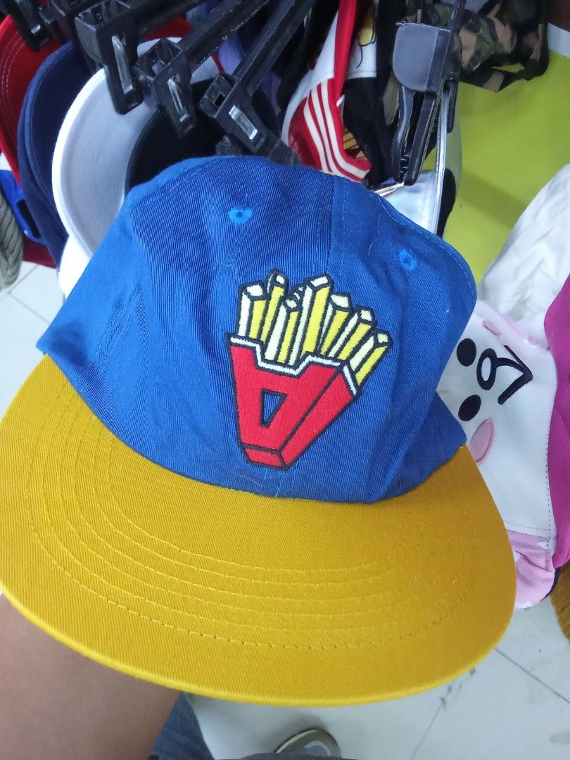 ADER Error French Fries Cap (Category: Caps & Hats) located in Manila. Submitted by nomsojyara49223 (Listing ID 1414295695, Image 1). Description: - Blue cap with a yellow brim - Features a French fries graphic - "ADER error" brand name embroidered on the back - Adjustable strap with black buckle.