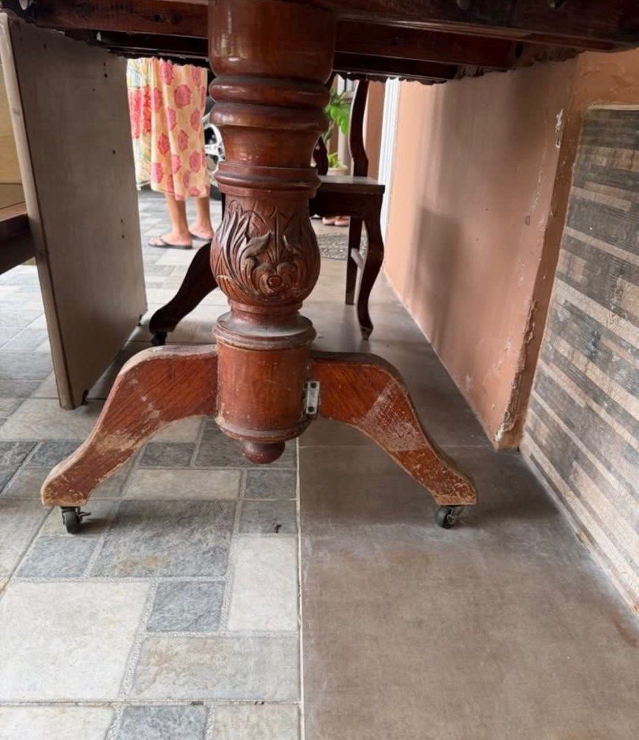 Antique Wooden Dining Table with Chairs (Category: Tables & Sets) located in Rizal. Submitted by caintarizal2024 (Listing ID 1414263769, Image 2). Description: - Antique oval dining table with issue - Features detailed carvings - Narra wood - Sturdy base with wheels for easy movement - Includes separate glass top - With 5 chairs (narra) Including office table table AS IS WHERE IS Last Price Posted .