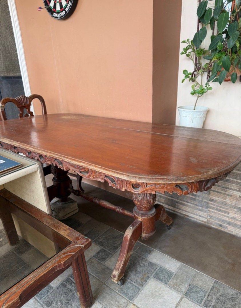 Antique Wooden Dining Table with Chairs (Category: Tables & Sets) located in Rizal. Submitted by caintarizal2024 (Listing ID 1414263769, Image 1). Description: - Antique oval dining table with issue - Features detailed carvings - Narra wood - Sturdy base with wheels for easy movement - Includes separate glass top - With 5 chairs (narra) Including office table table AS IS WHERE IS Last Price Posted .