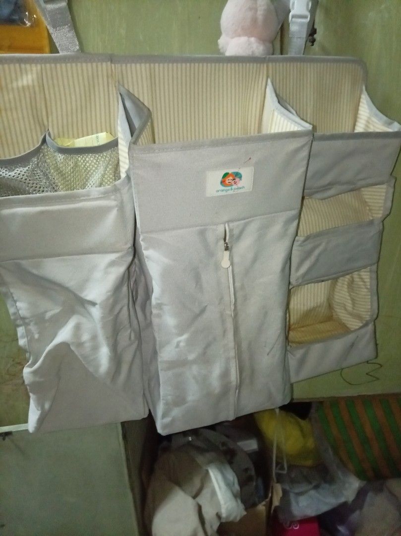 Baby Organizer with Multiple Pockets (Category: Diaper Bags & Wetbags) located in Caloocan City. Submitted by maynaito (Listing ID 1414411012, Image 2). Description: - Baby organizer for baby essentials. - Features multiple pockets and compartments. - Neutral color scheme. - Striped interior design. - Designed to hang for easy access. - Includes various sized pockets for diapers, wipes, and other necessities..