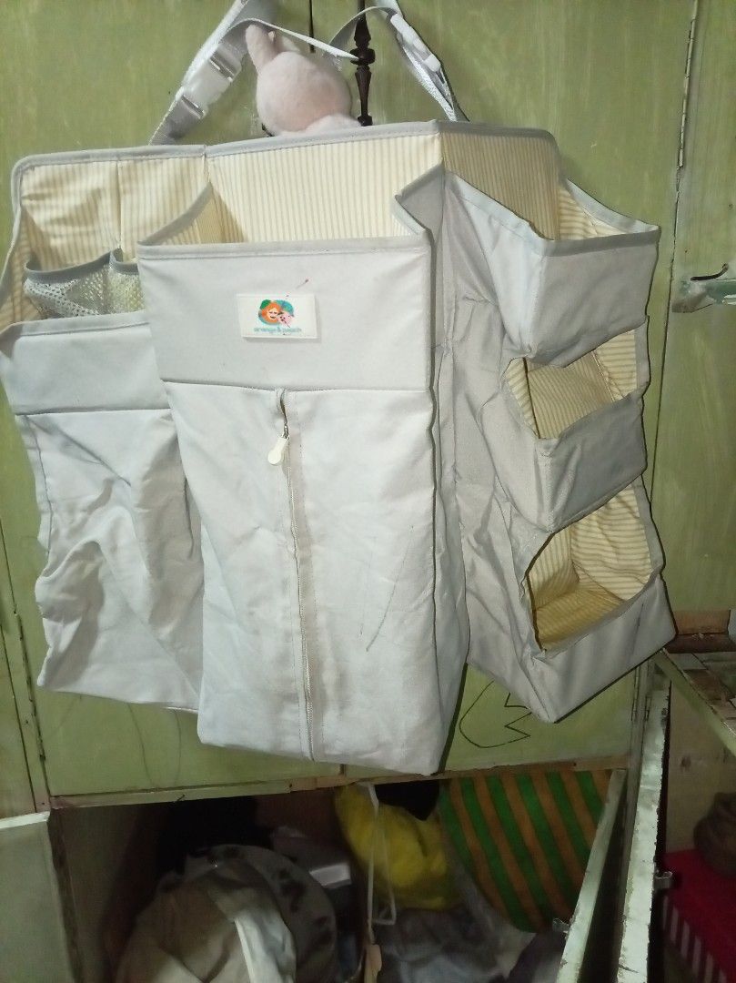 Baby Organizer with Multiple Pockets (Category: Diaper Bags & Wetbags) located in Caloocan City. Submitted by maynaito (Listing ID 1414411012, Image 1). Description: - Baby organizer for baby essentials. - Features multiple pockets and compartments. - Neutral color scheme. - Striped interior design. - Designed to hang for easy access. - Includes various sized pockets for diapers, wipes, and other necessities..