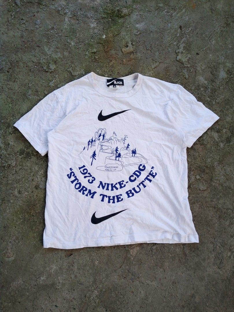 Black Comme des Garcons x Nike T-shirt (Category: Tshirts & Polo Shirts ) located in Caloocan City. Submitted by giriyeys793 (Listing ID 1414331345, Image 1). Description: - Nike x Comme des Garcons collaboration T-shirt - Features graphic print with "1973 NIKE-CDG STORM THE BUTTE" design - Size: M -Dimes 20W/26L - Made in Japan - Material: 100% cotton - Care: Hand wash recommended.