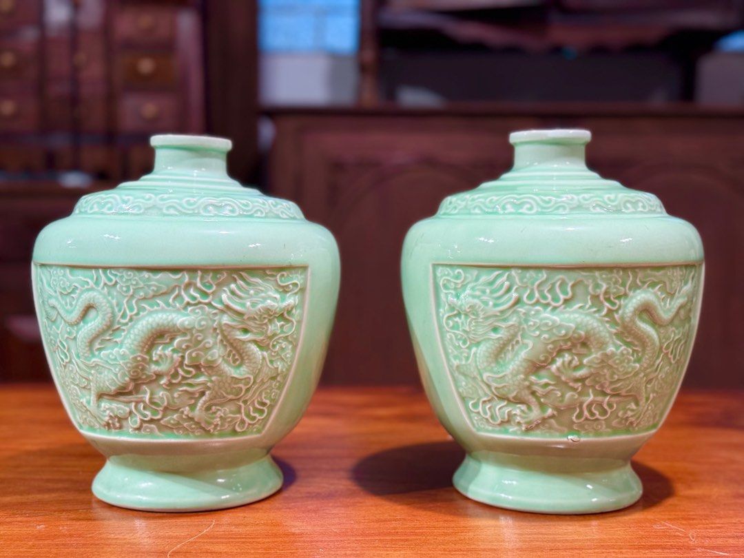 Chinese celadon-glazed porcelain jars (Category: Vases & Decorative Bowls) located in Manila. Submitted by sinaunang_gamit (Listing ID 1414340185, Image 1). Description: Chinese celadon-glazed porcelain jars They feature detailed, crisply carved and molded five-clawed dragons in relief on the exterior. The distinctive light blue-green hue is characteristic of traditional Chinese celadon glaze. The shape is a squat jar form with high shoulders and