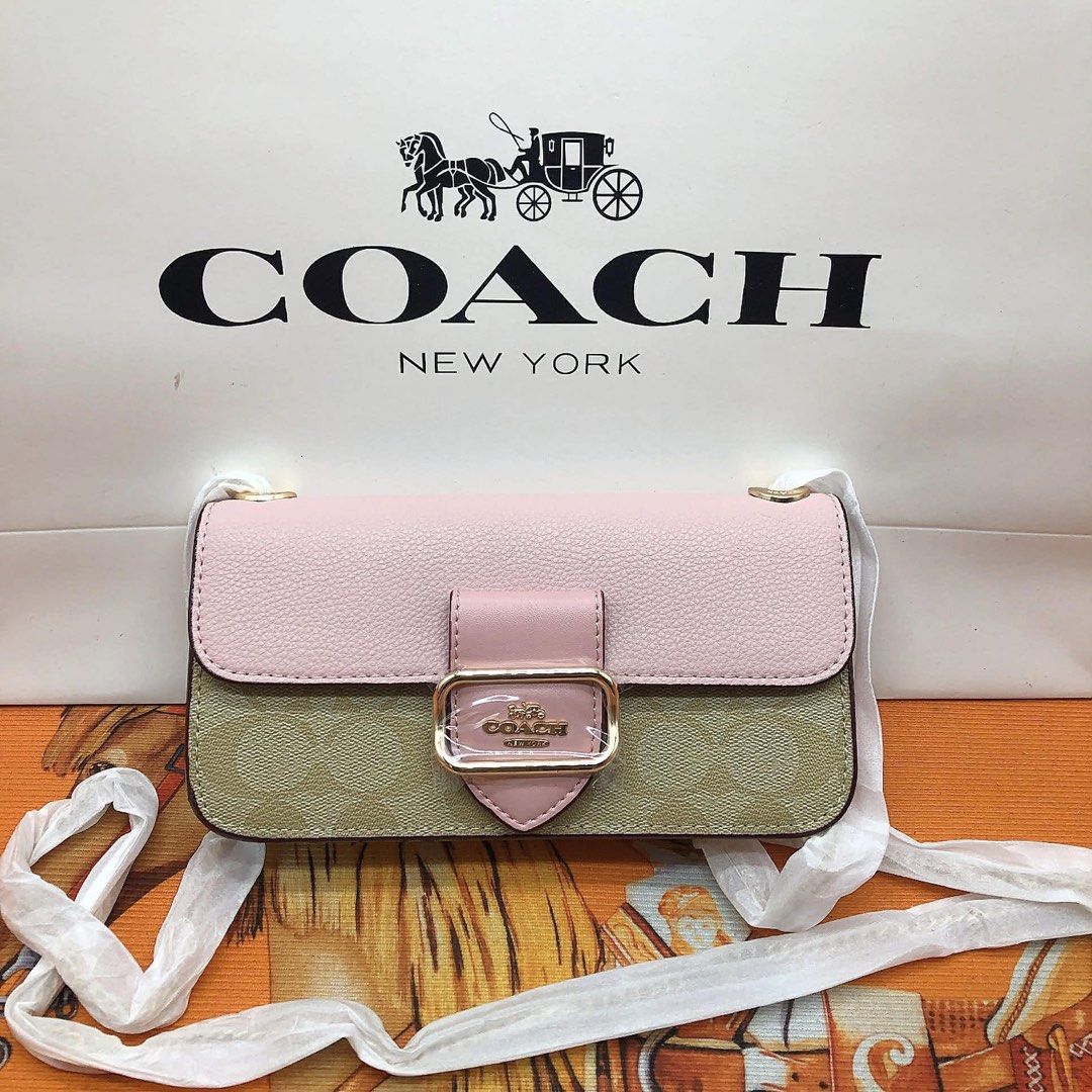 Coach Mini Shoulder Bag (Category: Luxury Bags & Wallets) located in Manila. Submitted by clairetot (Listing ID 1414332720, Image 2). Description: - Coach mini shoulder bag - Signature logo pattern - Chain strap - Flap closure with gold-tone buckle - Interior brand tag - Available colors: Brown, Pink, Navy - Includes Coach paper bag.