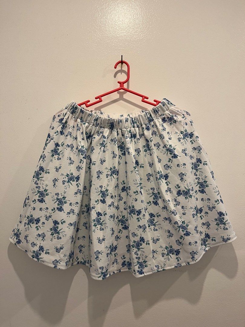 Floral Crop Top and Skirt Set (Category: Sets or Coordinates) located in Antipolo. Submitted by _gellavctrn (Listing ID 1414322113, Image 3). Description: - White fabric with blue floral prints - Halter-neck crop top with gathered bust and tie closure - Mini skirt with elastic waistband - Matching fabric and pattern for both pieces.