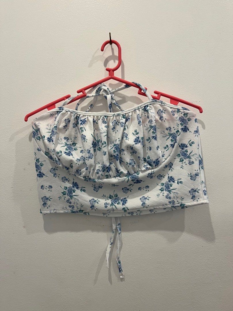 Floral Crop Top and Skirt Set (Category: Sets or Coordinates) located in Antipolo. Submitted by _gellavctrn (Listing ID 1414322113, Image 1). Description: - White fabric with blue floral prints - Halter-neck crop top with gathered bust and tie closure - Mini skirt with elastic waistband - Matching fabric and pattern for both pieces.