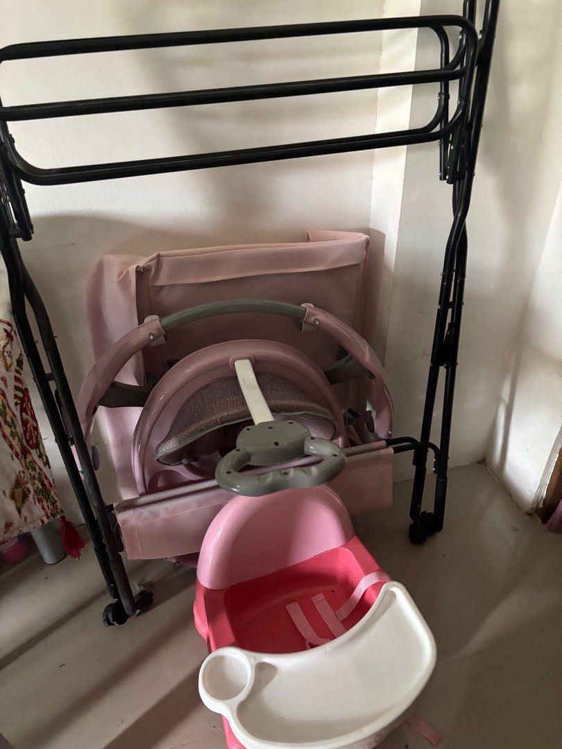 Foldable Baby Changing Table (Category: Changing Mats & Accessories) located in Binan City. Submitted by gracefully714 (Listing ID 1414300048, Image 2). Description: - Foldable baby changing table - Pink changing surface - Black metal frame - Side storage basket - Lower storage shelf - Wheels for easy movement - Includes baby care products.