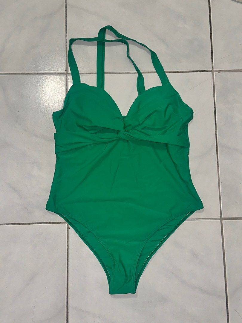 Green Halter Neck Swimsuit - Size L (Category: Bikinis & Swimsuits) located in Cavite. Submitted by iga_preloved (Listing ID 1414409308, Image 1). Description: Never been used Green one-piece swimsuit with halter neck straps. Features a knot detail at the bust. The label indicates the material is 80% Polyamide and 20% Elastane. Size L. Made in China..