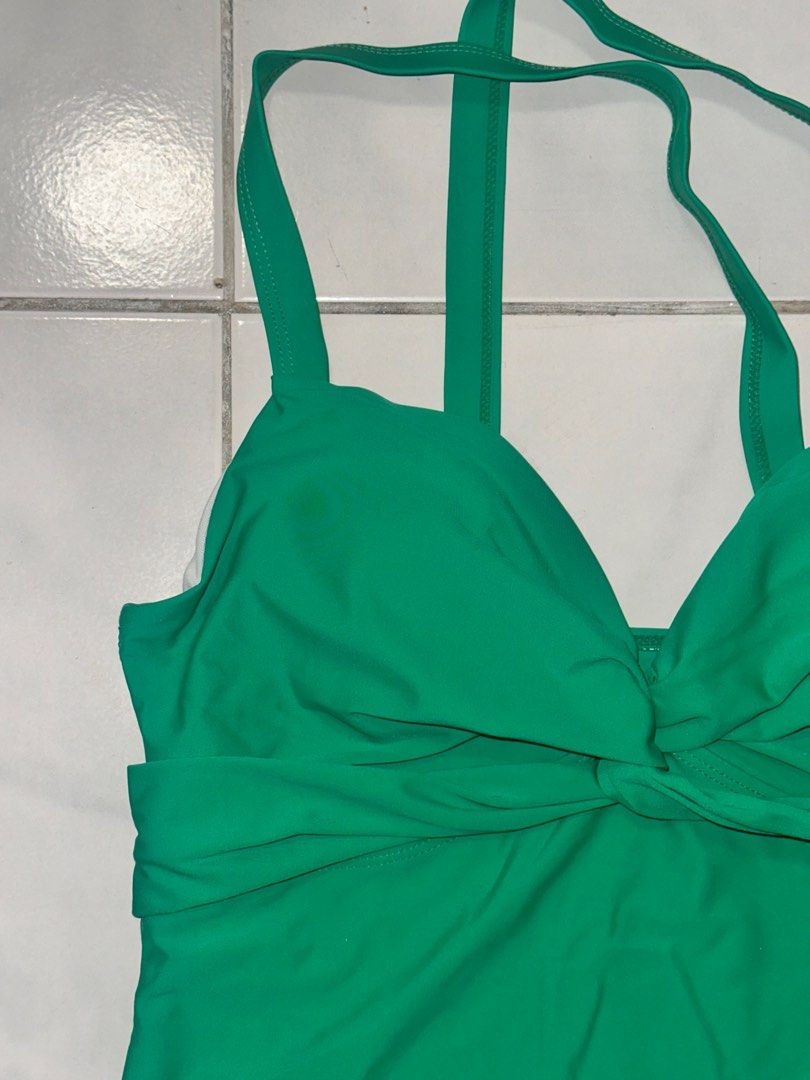 Green Halter Neck Swimsuit - Size L (Category: Bikinis & Swimsuits) located in Cavite. Submitted by iga_preloved (Listing ID 1414409308, Image 2). Description: Never been used Green one-piece swimsuit with halter neck straps. Features a knot detail at the bust. The label indicates the material is 80% Polyamide and 20% Elastane. Size L. Made in China..