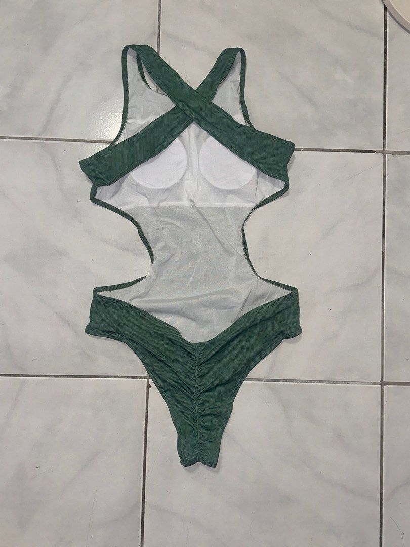 Green Ribbed Cutout Swimsuit - Size L (Category: Bikinis & Swimsuits) located in Cavite. Submitted by iga_preloved (Listing ID 1414409088, Image 2). Description: Never been used - Stylish green swimsuit - Unique cutout design - Ribbed texture - Criss-cross back - Size: L - Includes padding - Material: 82% polyester, 18% elastane - Perfect for beach or pool.