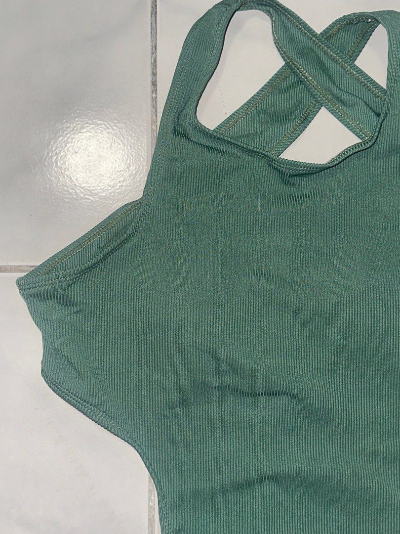 Green Ribbed Cutout Swimsuit - Size L (Category: Bikinis & Swimsuits) located in Cavite. Submitted by iga_preloved (Listing ID 1414409088, Image 3). Description: Never been used - Stylish green swimsuit - Unique cutout design - Ribbed texture - Criss-cross back - Size: L - Includes padding - Material: 82% polyester, 18% elastane - Perfect for beach or pool.