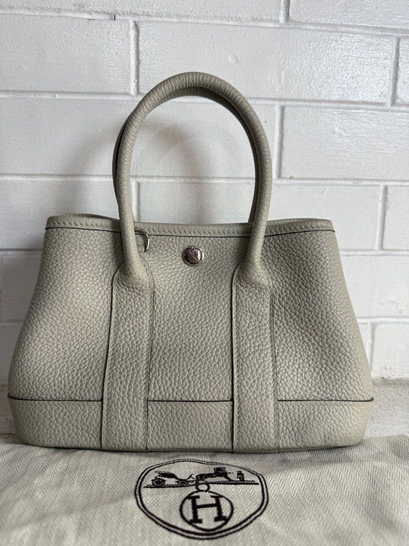 Hermes Garden Party TPM (Category: Luxury Bags & Wallets) located in Baguio. Submitted by drein30 (Listing ID 1414390339, Image 1). Description: - Hermes Garden Party handbag - Light grey exterior and interior - Structured shape - Two top handles - Snap closure - Silver-toned hardware - Interior zippered pocket - Includes dust bag.