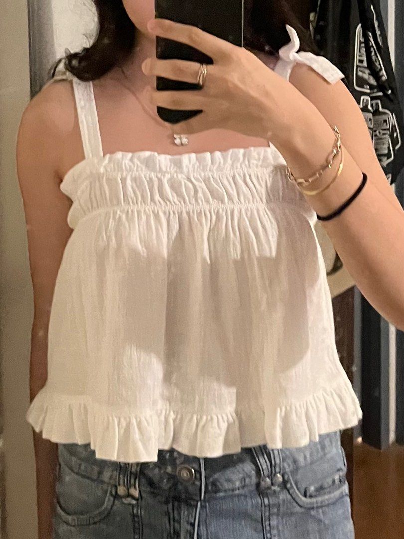 H&M White Ruffle Top with Tie Straps (Category: Sleeveless) located in Rizal. Submitted by juwostar (Listing ID 1414371160, Image 1). Description: - Very cute when worn !! - Got this from the kids section lang din hehe but it fits xs-s naman :] MOP: GCASH MOD: GGX, FLASH, OR LALAMOVE.