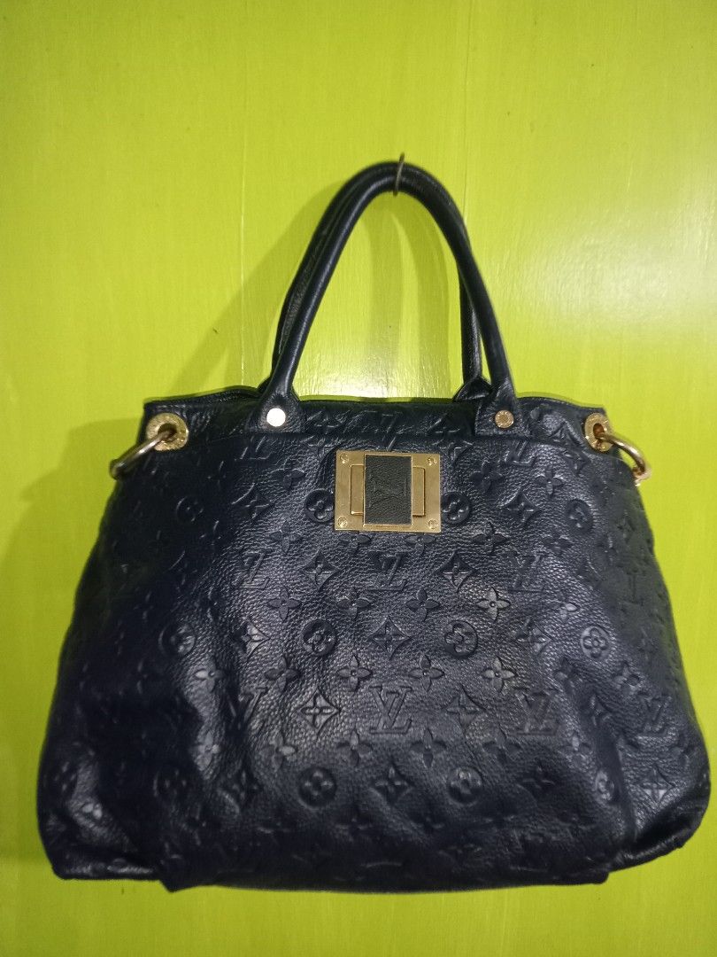 Louis Vuitton Handbag (Category: Luxury Bags & Wallets) located in San Juan City. Submitted by melodybaron19 (Listing ID 1414293001, Image 2). Description: - Authentic Louis Vuitton handbag - Dark blue color - Textured exterior with LV monogram - Top handle design - Gold-toned hardware - Rectangular gold plate detail - Spacious interior - Ideal for everyday use.