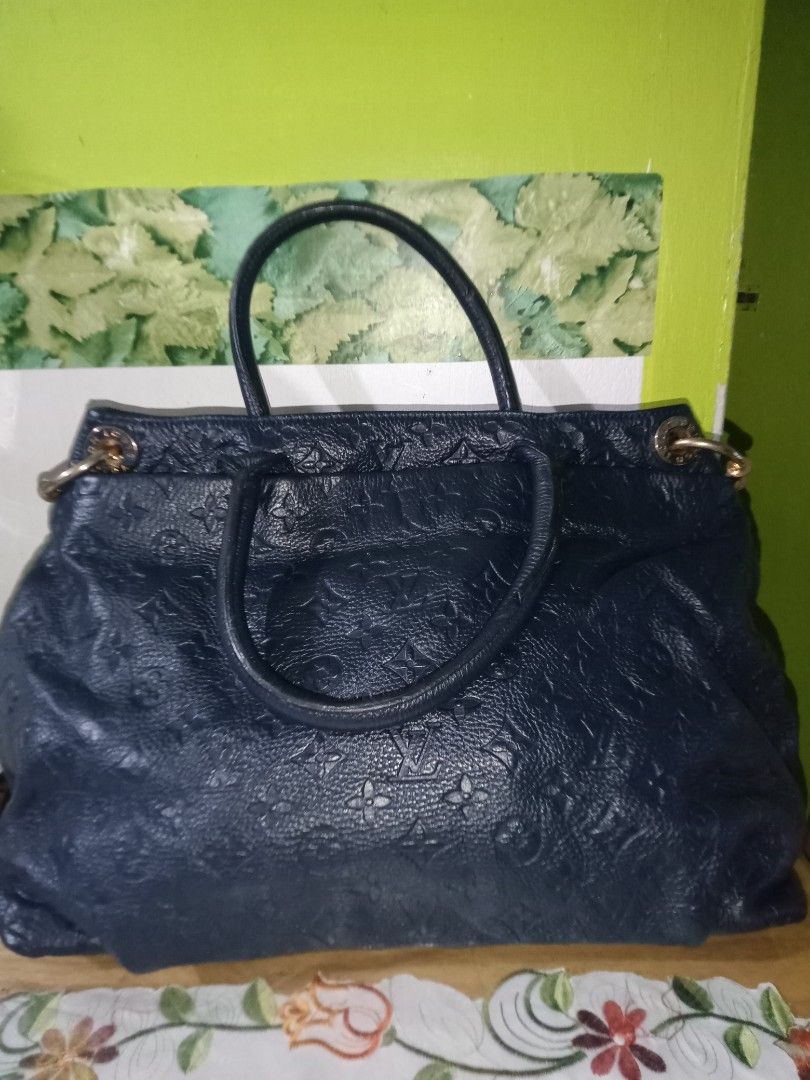 Louis Vuitton Handbag (Category: Luxury Bags & Wallets) located in San Juan City. Submitted by melodybaron19 (Listing ID 1414293001, Image 3). Description: - Authentic Louis Vuitton handbag - Dark blue color - Textured exterior with LV monogram - Top handle design - Gold-toned hardware - Rectangular gold plate detail - Spacious interior - Ideal for everyday use.