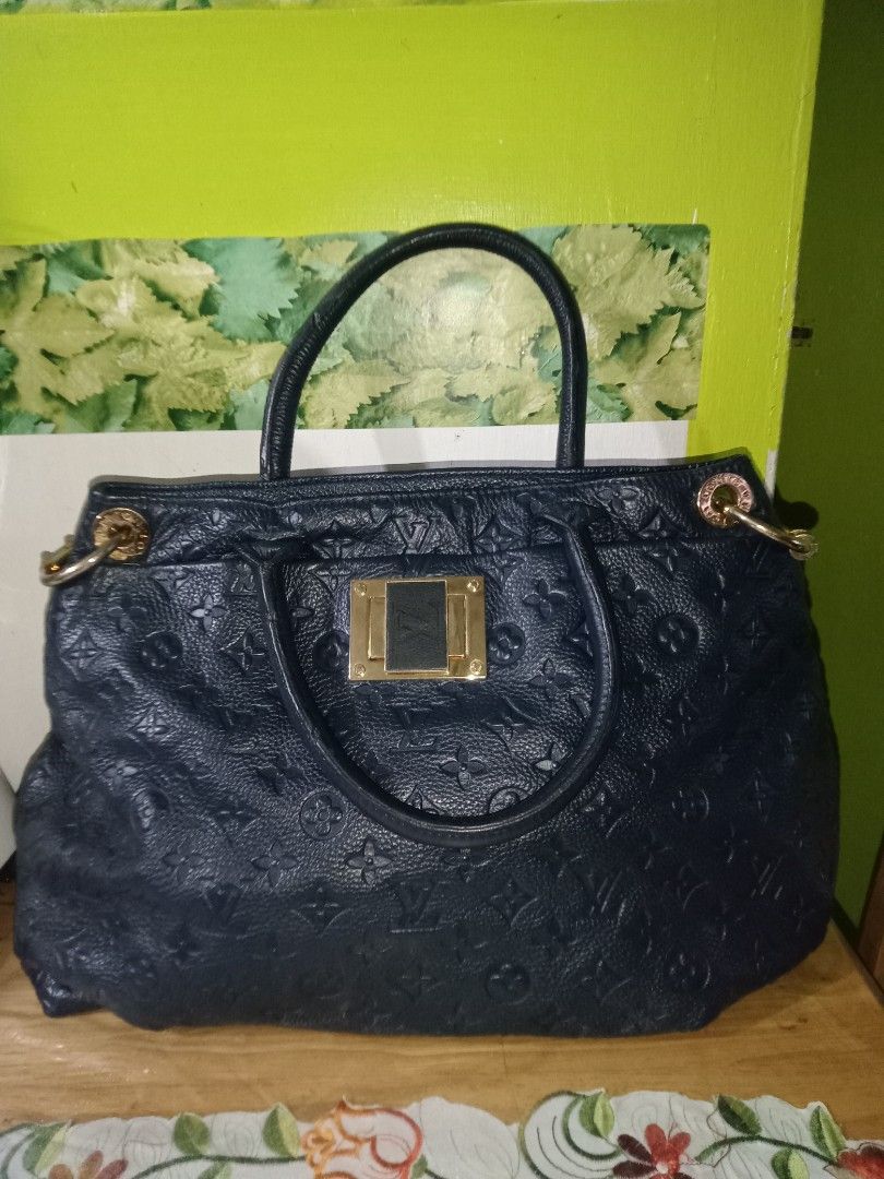 Louis Vuitton Handbag (Category: Luxury Bags & Wallets) located in San Juan City. Submitted by melodybaron19 (Listing ID 1414293001, Image 1). Description: - Authentic Louis Vuitton handbag - Dark blue color - Textured exterior with LV monogram - Top handle design - Gold-toned hardware - Rectangular gold plate detail - Spacious interior - Ideal for everyday use.