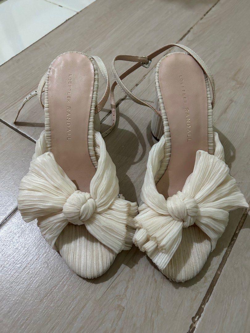 Pearl White Loeffler Randall Bow Sandals (Category: Flats & Sandals) located in Taguig. Submitted by _wardrobecleanse (Listing ID 1414270838, Image 2). Description: - Loeffler Randall sandals - Unique bow design - Cream color - Ankle straps - Size: 5.5 US - Signs of wear on soles - Adds sophistication to any outfit Used only once for my wedding.