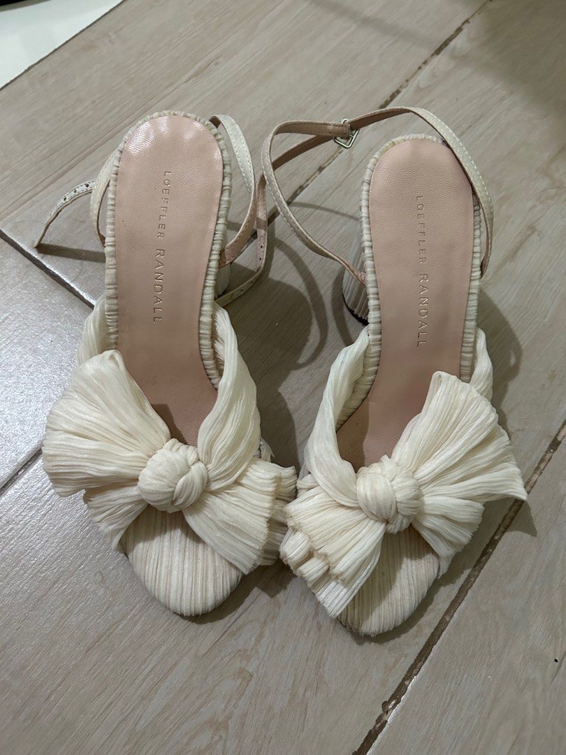 Pearl White Loeffler Randall Bow Sandals (Category: Flats & Sandals) located in Taguig. Submitted by _wardrobecleanse (Listing ID 1414270838, Image 1). Description: - Loeffler Randall sandals - Unique bow design - Cream color - Ankle straps - Size: 5.5 US - Signs of wear on soles - Adds sophistication to any outfit Used only once for my wedding.
