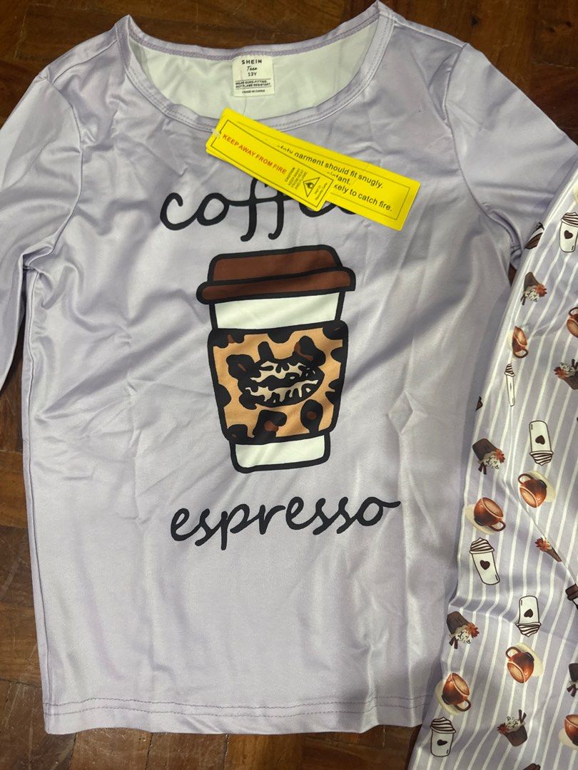 SHEIN Kids Coffee Espresso Pajama Set (Category: Undergarments & Loungewear) located in Mandaluyong City. Submitted by mjmc56 (Listing ID 1414270576, Image 2). Description: - SHEIN Kids pajama set - Size: Teen 13Y - Top: Light purple with "coffee espresso" graphic - Pants: Striped with coffee cup illustrations - Long-sleeved top and pants.