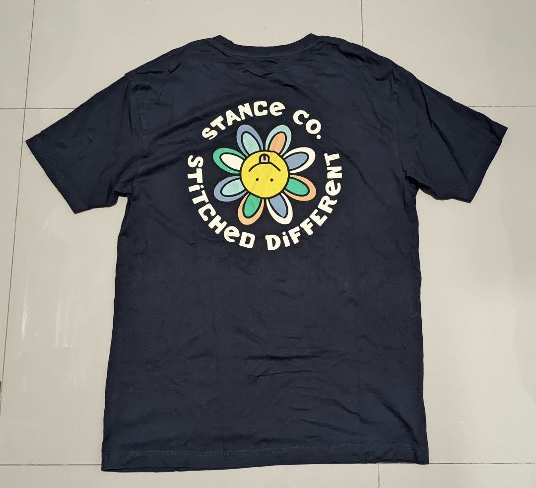 Stance Co. Flower Graphic Tee - Navy Blue (Category: Tshirts & Polo Shirts ) located in Caloocan City. Submitted by wupeeram (Listing ID 1414397961, Image 1). Description: - Navy blue Stance Co. t-shirt - Features a flower graphic on the front - Back graphic includes "Stance Co. Stitched Different" text - Crew neck and short sleeves - Measurements: L30 W21 - Material: 100% cotton.