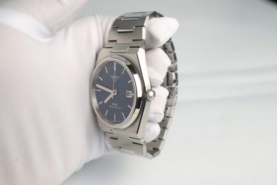 Tissot PRX Powermatic 80 Automatic Watch (Category: Luxury Watches) located in Cabanatuan. Submitted by albertgonzales27 (Listing ID 1414330158, Image 3). Description: - Tissot PRX Powermatic 80 - Blue dial with date display - Stainless steel case and bracelet - Transparent case back - Features the Tissot 1853 logo - Powermatic 80 movement - Crown on the right side.