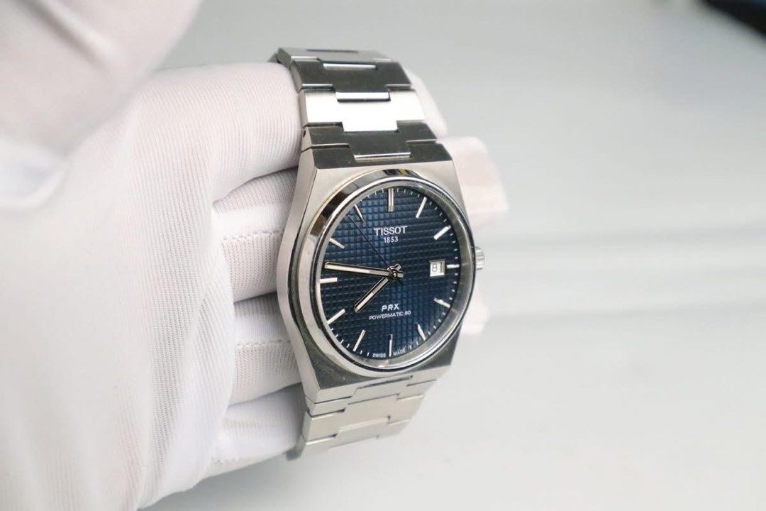 Tissot PRX Powermatic 80 Automatic Watch (Category: Luxury Watches) located in Cabanatuan. Submitted by albertgonzales27 (Listing ID 1414330158, Image 2). Description: - Tissot PRX Powermatic 80 - Blue dial with date display - Stainless steel case and bracelet - Transparent case back - Features the Tissot 1853 logo - Powermatic 80 movement - Crown on the right side.