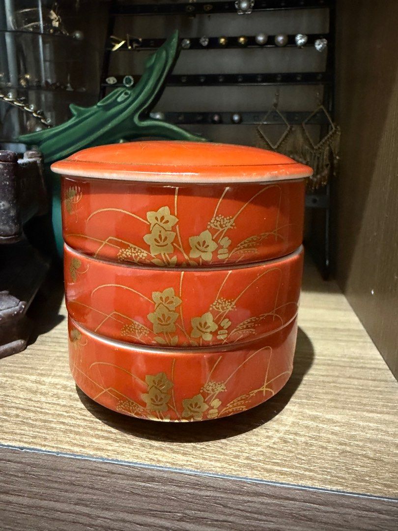 vintage Otagiri Kutani stackable box Jewelry storage (Category: Food Organization & Storage) located in Rizal. Submitted by caintarizal2024 (Listing ID 1414265566, Image 1). Description: The item pictured is a vintage Otagiri Kutani stackable box or set of bowls. It features an iron-red porcelain body with gold gilding of a floral design. The item is a three-tiered stacking container with a lid. It can be used for serving sauces, sushi, or as a b