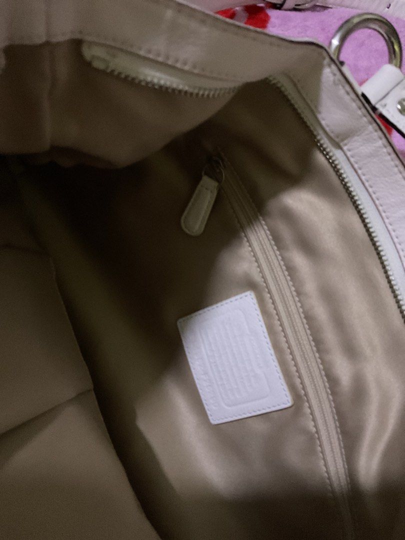 white Coach Signature Shoulder Bag (Category: Luxury Bags & Wallets) located in Mandaluyong City. Submitted by izeehnflauta (Listing ID 1414361894, Image 3). Description: - Coach shoulder bag with signature pattern - Front pocket with buckle closure - Detachable shoulder strap - Top handle - Interior zip pocket and Coach label - Beige and white color scheme - Spacious interior.