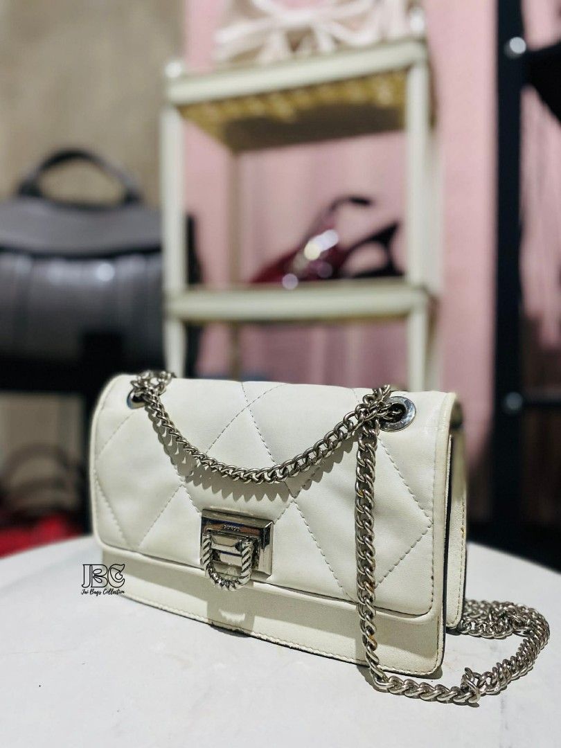 White Quilted Chain Bag (Category: Luxury Bags & Wallets) located in Aloran. Submitted by mysticwhale-2026 (Listing ID 1414325601, Image 1). Description: Elegant white quilted handbag with a silver chain strap. Features a rectangular shape with a secure clasp closure. The bag has a diamond-stitched pattern, adding a touch of sophistication. Perfect for everyday use or special occasions. A stylish accessory to complement any outfit..