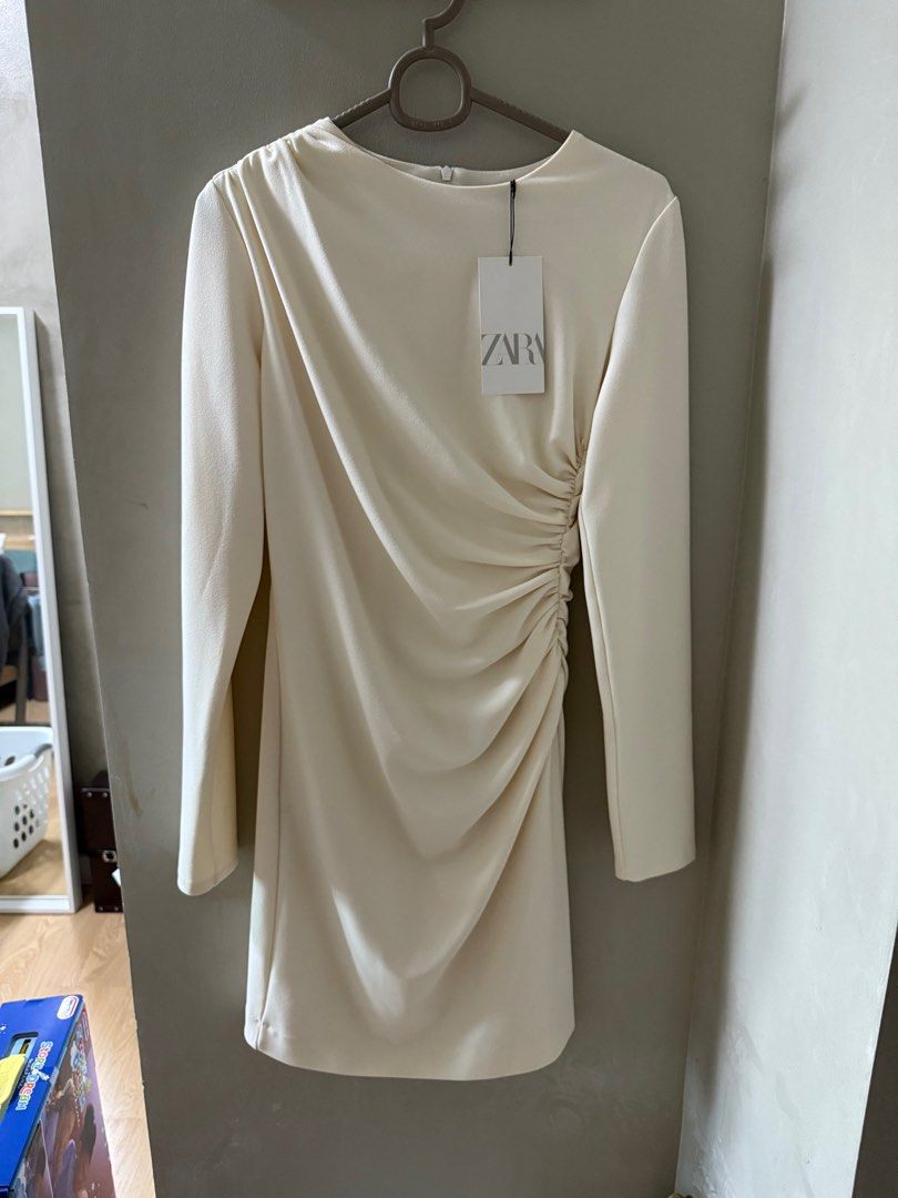 Zara Ruched Dress - Size M (Category: Dresses) located in Pasig City. Submitted by honsolo (Listing ID 1414409977, Image 1). Description: - Zara dress - Size M - Cream color - Ruched side design - Long sleeves - Round neckline - Original price: ₱2495 Rfs: decluttering.