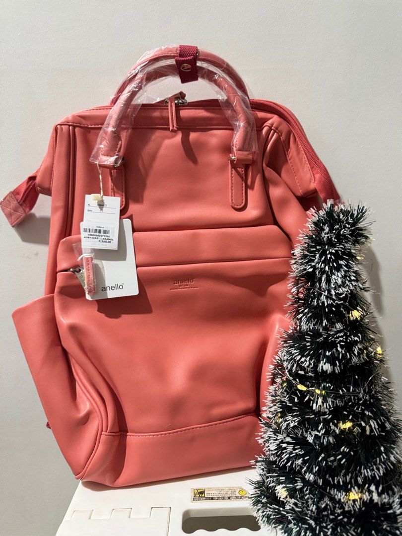 Anello Backpack - Pink /Camel (Category: Backpacks) located in Bacoor. Submitted by natureal.healing03 (Listing ID 1414452477, Image 1). Description: - Authentic Anello backpack - Stylish pink color - Top handle for easy carrying - Adjustable shoulder straps for comfort - Convenient front and side pockets - Secure zipper closure - Features the Anello brand name - Designed by Carriel Co. in Japan.