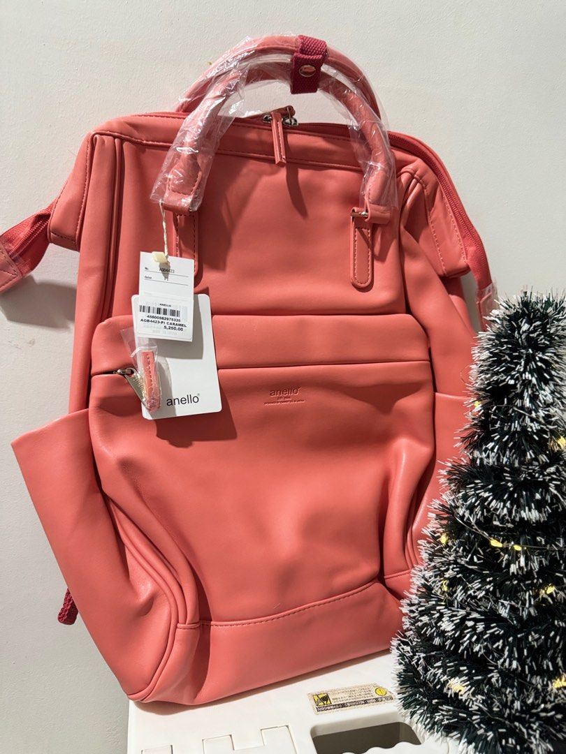 Anello Backpack - Pink /Camel (Category: Backpacks) located in Bacoor. Submitted by natureal.healing03 (Listing ID 1414452477, Image 2). Description: - Authentic Anello backpack - Stylish pink color - Top handle for easy carrying - Adjustable shoulder straps for comfort - Convenient front and side pockets - Secure zipper closure - Features the Anello brand name - Designed by Carriel Co. in Japan.