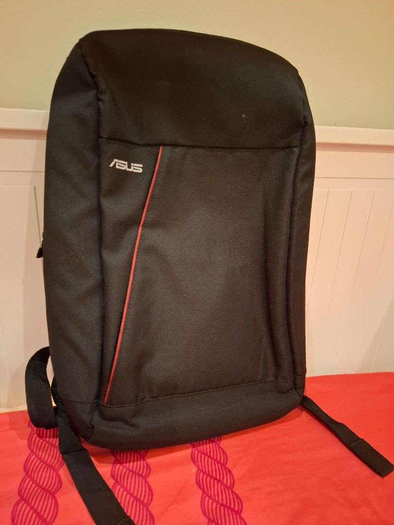 ASUS Laptop Backpack (Category: Backpacks) located in Manila. Submitted by warmcat-ee9368 (Listing ID 1414579641, Image 1). Description: - Black ASUS laptop backpack - Red accent line - Padded back for comfort - Adjustable shoulder straps - Double zipper closure - Made of durable fabric - Perfect for laptops and essentials.