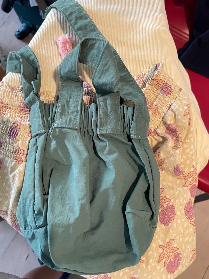 Beyond The Vines Micro Dumpling Bag - Fern Green (Category: Cross-body Bags) located in Makati City. Submitted by prebyella23 (Listing ID 1414519998, Image 3). Description: - Beyond The Vines Micro Dumpling Bag - Color: Fern Green - Features: Drawstring closure, small front pocket - Size: Compact, ideal for essentials - Condition: As shown in images, tiny tiny stain seen on last photo - not noticeable .